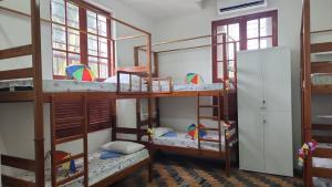 a room with four bunk beds and a refrigerator at Pousada Convento da Conceição in Olinda