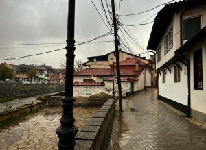 a street with a light pole on a flooded street at APARTMENT Marash in Prizren
