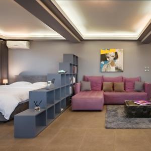 a bedroom with a purple couch and a bed at Boutique Apartment in Athens Center in Athens