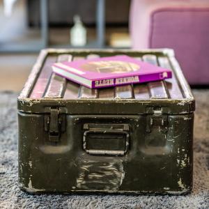 an old black suitcase with a pink book on top at Boutique Apartment in Athens Center in Athens