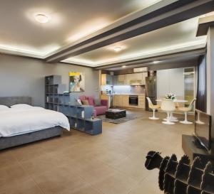 a bedroom with a bed and a living room at Boutique Apartment in Athens Center in Athens