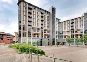 a large building with tall buildings in a city at All Saints Apartments 404 by Week2Week in Newcastle upon Tyne