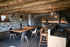 a dining room with a wooden table and chairs at Buron de Léon, en plein cœur de l Aubrac in Laguiole