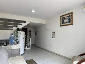 a living room with a refrigerator and a staircase at Valentina Ramos Pousada - Joinville-SC in Joinville
