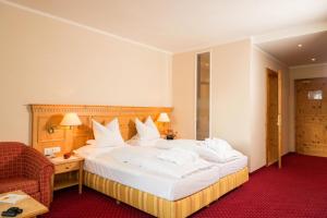 A bed or beds in a room at Hotel Regina