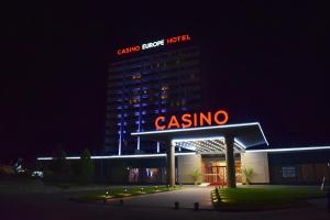 a building with a casino sign on top at night at Europe Hotel & Casino All Inclusive in Sunny Beach