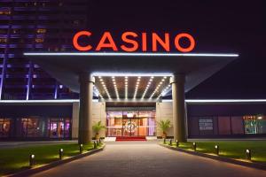 a casino sign on the front of a building at night at Europe Hotel & Casino All Inclusive in Sunny Beach