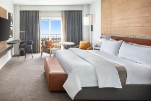 a hotel room with a large bed and a television at The Westin Dallas Stonebriar Golf Resort & Spa in Frisco