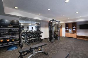 a fitness room with a lot of equipment in it at Fairfield Inn & Suites Kansas City Airport in Kansas City