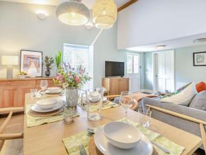 a dining room with a table and a couch at 2 Bed in Taunton 88884 in Isle Brewers