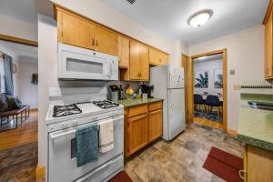 a kitchen with a stove and a refrigerator at Poker/Game Room - BBQ - Backyard fun in Minneapolis