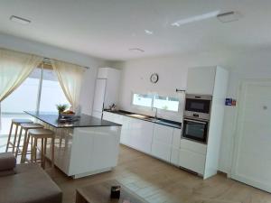 a kitchen with white cabinets and a counter top at La Catumbela in Tuineje