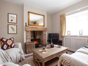 a living room with a fireplace and a table at 2 Bed in Richmond 74305 in Barton