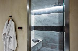 a bathroom with a shower with a glass door at The Sand Villas - 5star Living on the Beach in Agios Nikolaos