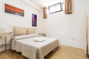 a bedroom with a bed in a white room at Villa Greta By Vivimy in Parabita