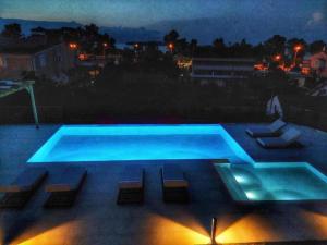 a swimming pool at night with lights at Casa Grande Private Luxury Villa in Alykes Potamou +84 photos