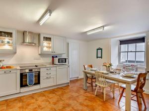 a kitchen and dining room with a table and chairs at 2 Bed in Marazion 82154 in Marazion