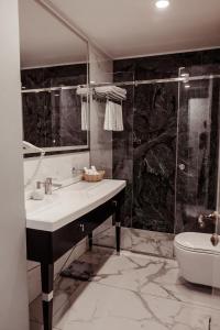 y baño con lavabo y ducha. en Time Hotel&SPA, en Chişinău