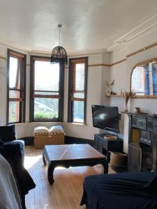 a living room with a couch and a table at Edwardian Villa by the sea-side in Walton-on-the-Naze