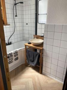 a bathroom with a sink and a bath tub at Edwardian Villa by the sea-side in Walton-on-the-Naze