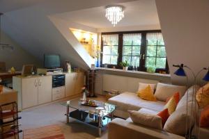 a living room with a couch and a table at Ferienwohnung Orchidee in Bad Münstereifel