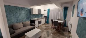 a living room with a couch and a table at Anelisse Apartments in Eforie Nord