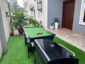 a pool table sitting on the grass in a backyard at Maestro in Lagos