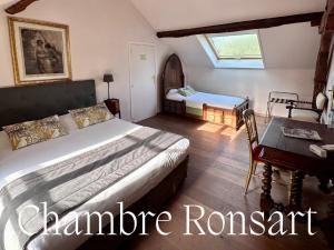 a bedroom with a bed and a table and a desk at Domaine de la Butte Ronde in La Boissière-École +40 photos