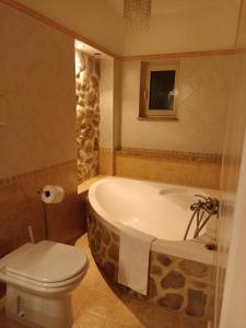 a bathroom with a bath tub and a toilet at Casa vacanze home cecilie in Reggio di Calabria