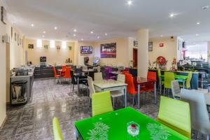 a restaurant with colorful chairs and tables in a cafeteria at Slina Hotel Brussels in Brussels