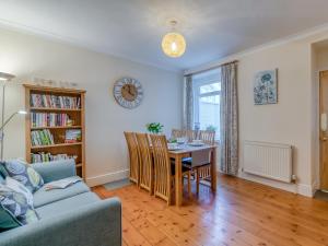 a living room with a table and a couch at 3 Bed in Barnstaple 77506 in Bishops Tawton