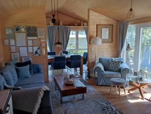 a living room with a blue couch and a table at Tiny House "Wolke 7" in Göhren-Lebbin