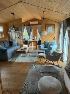 a living room with blue couches and a table at Tiny House "Wolke 7" in Göhren-Lebbin