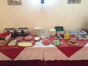 a table with plates of food on top of it at Health Habitat Hotel & Slimming Resort in Pedoulas +32 photos