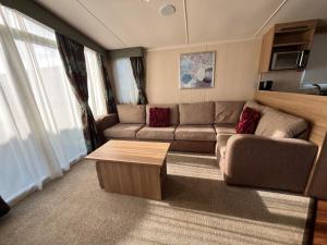 a living room with a couch and a coffee table at Bittern 13, Scratby - California Cliffs, Parkdean, sleeps 6, pet friendly, bed linen and towels included - close to the beach in Great Yarmouth