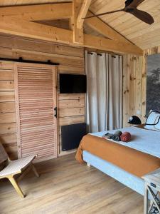 a bedroom with a bed and a wooden ceiling at VillaCanau in Lacanau