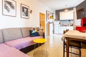 a living room with a couch and a table at Seaview Holiday Apartments in Slatine
