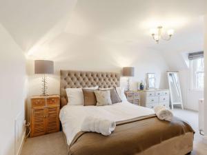 a white bedroom with a large bed and a dresser at 4 Bed in Wick 91390 in Wick