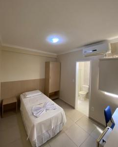 una camera ospedaliera con un letto e uno schermo per proiezione di Hotel Rio Center a Juazeiro