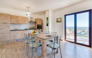 a kitchen and dining room with a table and chairs at Badolato Apartments in Badolato