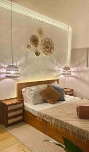a bedroom with a bed with two lights on it at The White Villa in Lipa in Lipa
