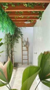 a room with a ladder and some plants in it at The White Villa in Lipa in Lipa