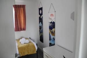 a small bedroom with a bed and a window at Coolfin House - London Excel in London
