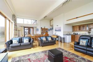 a living room with two couches and a kitchen at The Old Signal House in Niton