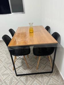 a table with a glass vase on top of it at Apartamento em Praia Grande in Praia Grande