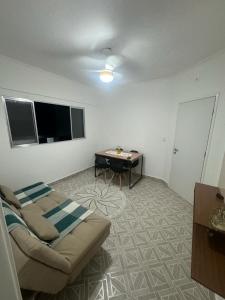 a living room with a couch and a table at Apartamento em Praia Grande in Praia Grande