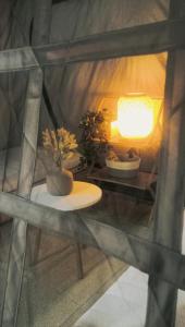 a room with a table and a lamp and plants at Cozy and Spacious 2 Bedroom, Family Indoor Camping Icity Shah alam-MY in Shah Alam +18 photos