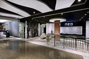 a lobby with a noco sign on the wall in a building at Neo Dipatiukur Bandung by ASTON in Bandung