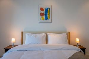 a bedroom with a bed with two lamps on tables at Deluxe - Sea view - Dubai Marina in Dubai +10 photos