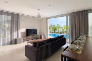 a living room with a couch and a table at City Napa Seaview Villas - Villa 4 in Ayia Napa